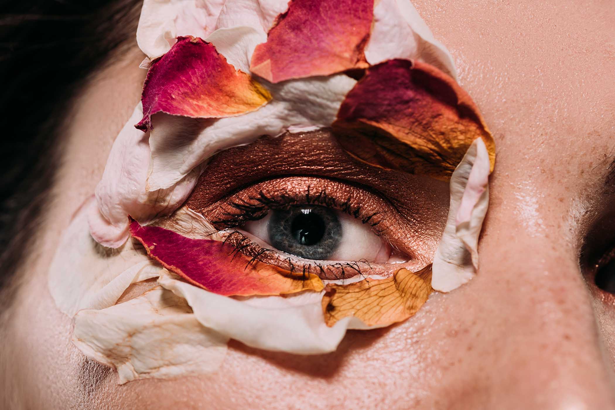 close-up-of-beautiful-girl-with-flower-petals-arou-PYZC3P7.jpg